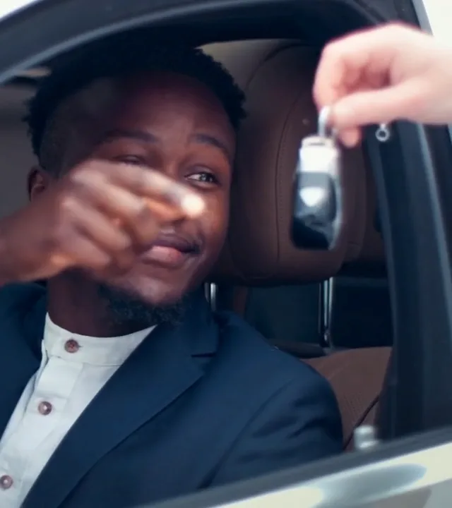 Carkey Masters technician handing a car key to a driver in Nairobi
