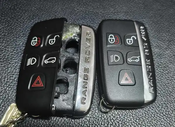 Range Rover smart key with a split, open shell (left) and the same key in a new shell (right), repaired by Carkey Masters